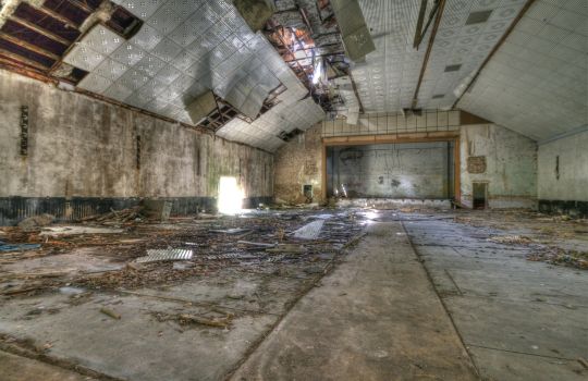 Einsturzgefährdete Halle mit kaputter Decke.